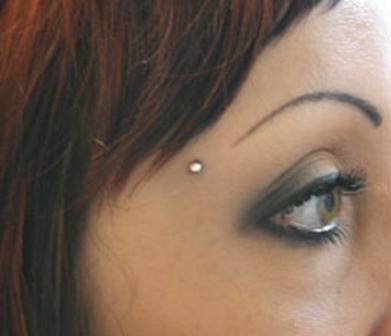 Beauteous eyed young lady with barbells pierced near to right eyebrow