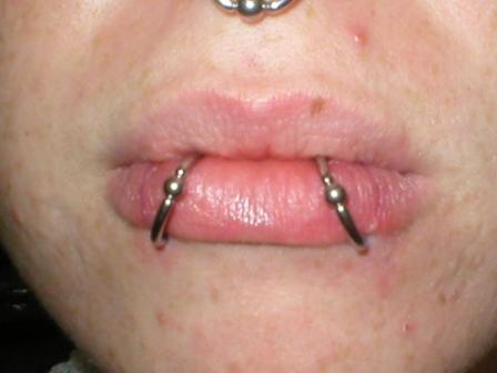  groove above (philtrum) the upper lip and the term 'labret piercings' is 