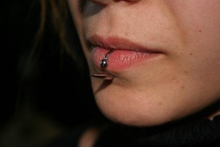 Close up of a pierced lip ring and labret lips-piercing-22