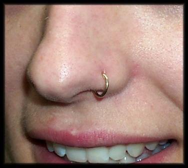 Close-up of a woman with a golden nose piercing nose-piercing-1