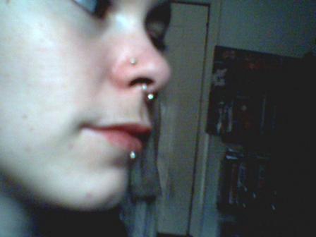 Girl shows her nose, septum and labret piercings nose-piercing-32