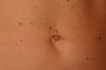 Golden Ring – Navel Piercing. A golden ring pierced on navel