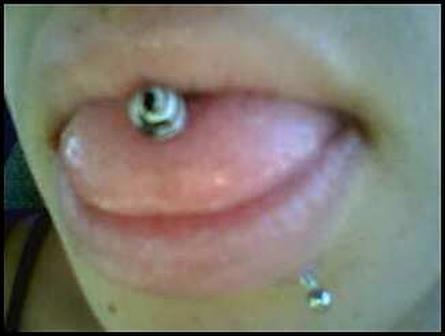 Extreme close up of a tongue and labret piercings tongue-piercing-28