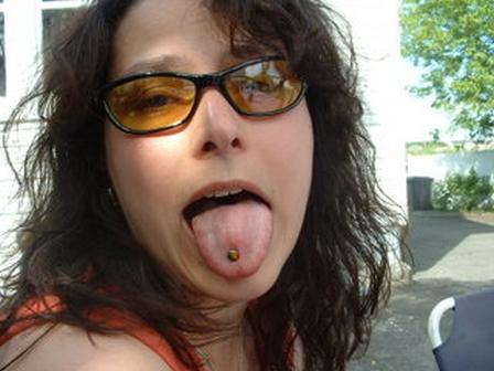 Girl in a trendy shades shows her tongue piercing tongue-piercing-30