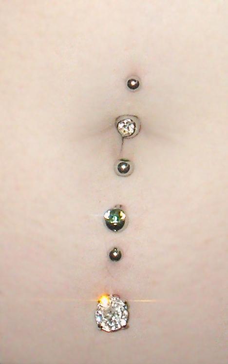 2 belly piercings. Three navel piercings