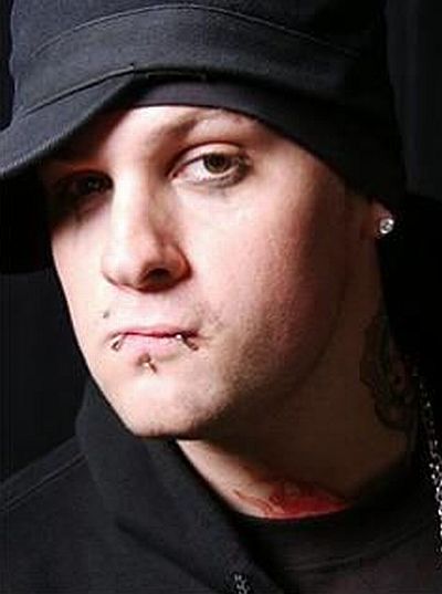 Benji Madden with his labret, monroe and snakebite piercing.