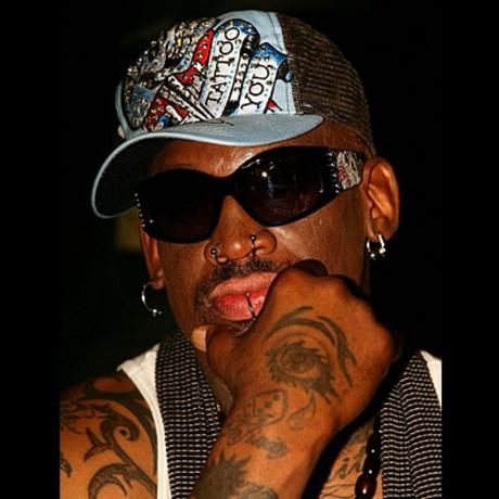 Basketball player Dennis Rodman with his tattoos and ear, nose and lower lip 