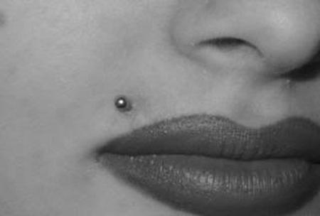 A black and white view of monroe lip piercing.