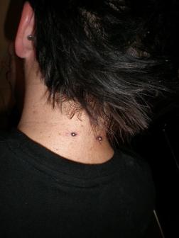 A guy showing his nape neck piercing. Nice And Simple Nape Piercing