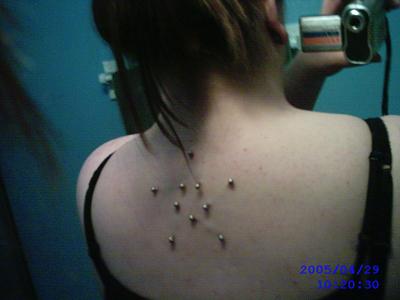 Girl With Star Shaped Back Piercing