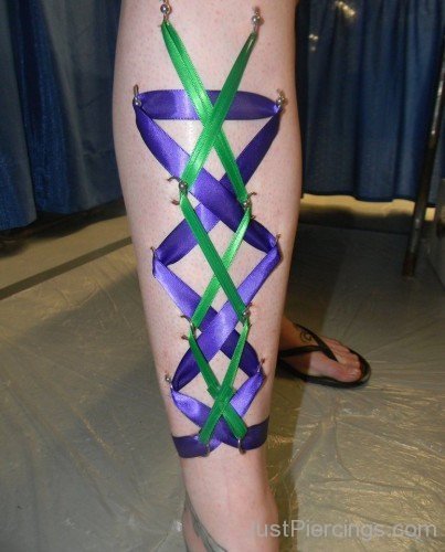 Purple And Green Corset Piercing