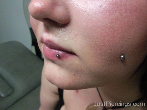 Cheek And Labret Piercing
