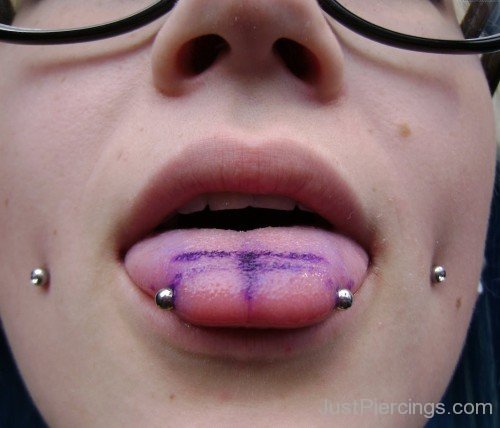 Cheek And Horizontal Tongue Piercings
