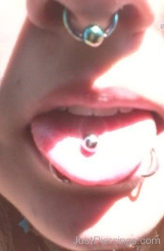 Dolphin Bites Septum And Tongue Piercing