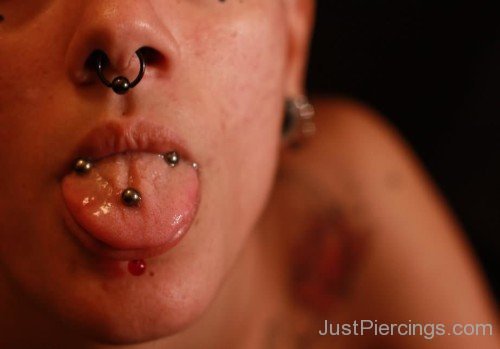 Septum Labret And Horizontal Tongue Piercing