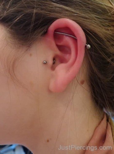 Tragus And Scaffold Piercing On Girl Left Ear
