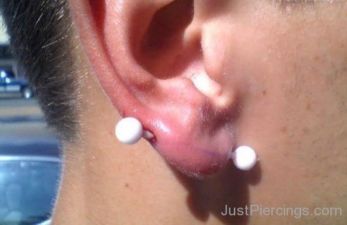 Transverse Lobe Piercing With White Barbell