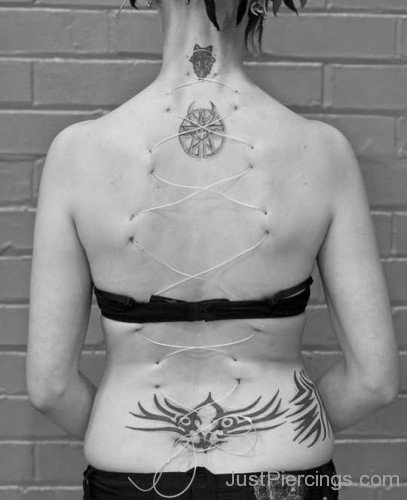 Tribal Lowerback And Surface Weave Piercing
