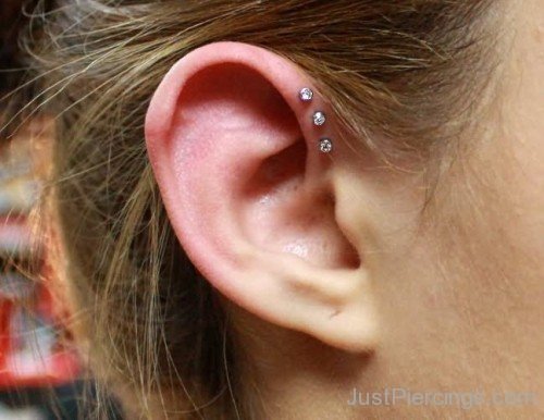 Triple Pinna Piercing On Girl Right Ear