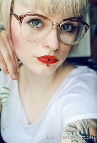 Vertical Labret Piercing And Tattoo On Arm