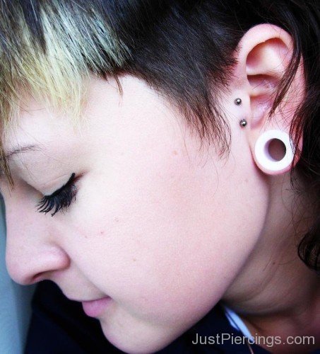 Vertical Tragus Piercing And Lobe Stretching