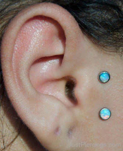 Vertical Tragus Piercing With Blue Studs