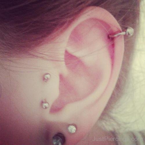 Vertical Tragus,Helix And Lobe Piercing