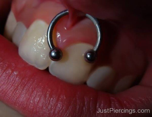Close Up Of Smiley Piercing.