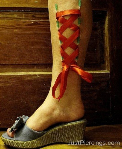 Corset Piercing On Right Leg With Red Ribbon-JP123