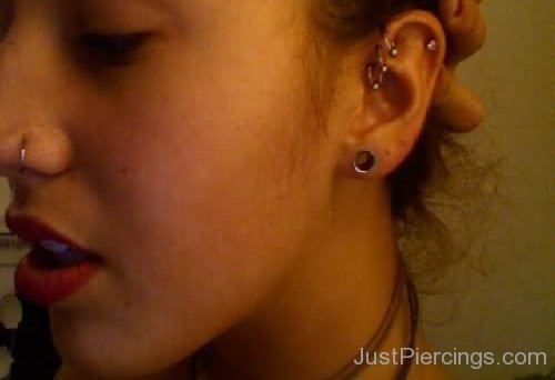 Girl Showing Her Lobe And Pinna Piercings On Left Ear-JP123