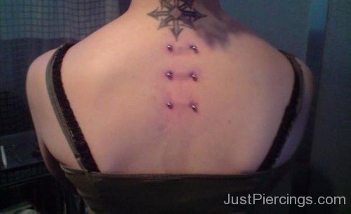 Arrows Tattoo And Surafce Piercings On Back-JP12302
