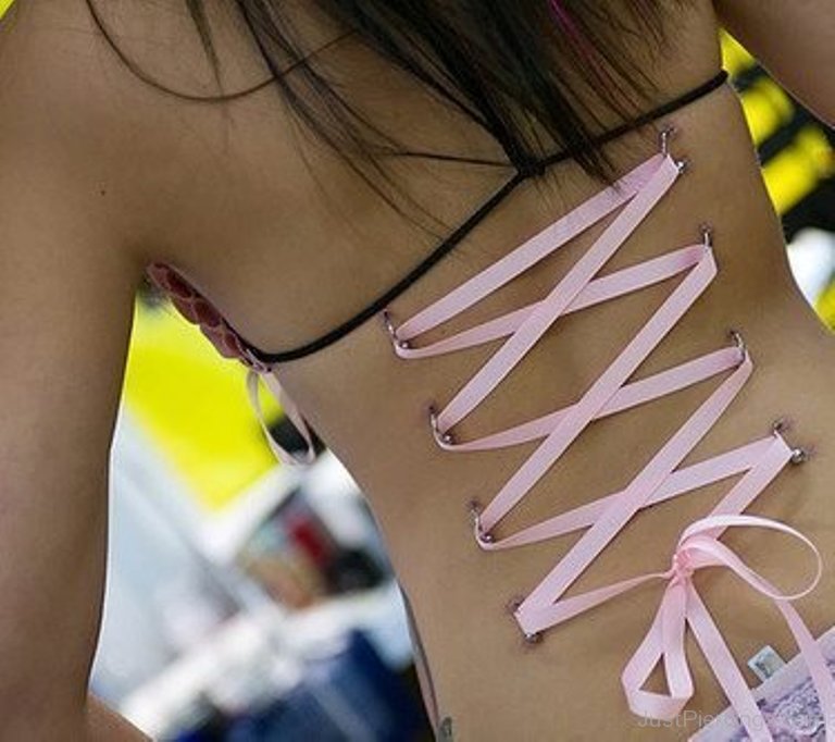 Corset Piercing On Back With Pink Ribbon.