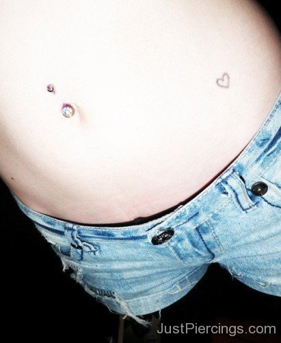 Cutie Navel Piercing And Heart Tattoo On Belly-JP12343