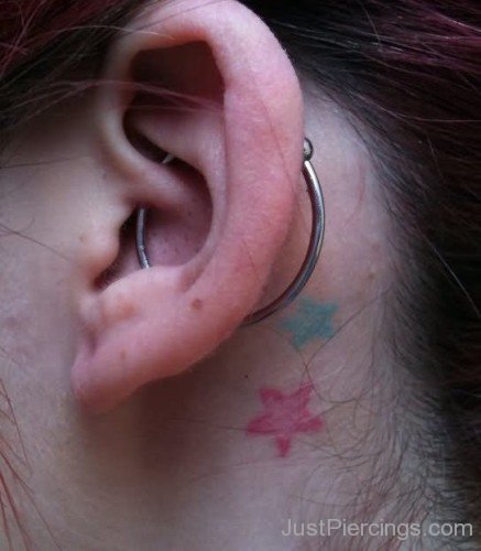Flower Tattoos And Large Orbital Piercing On Girl Left Ear-JP12326