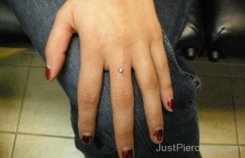 Hand Dermal Piercing On Middle Finger-JP12305
