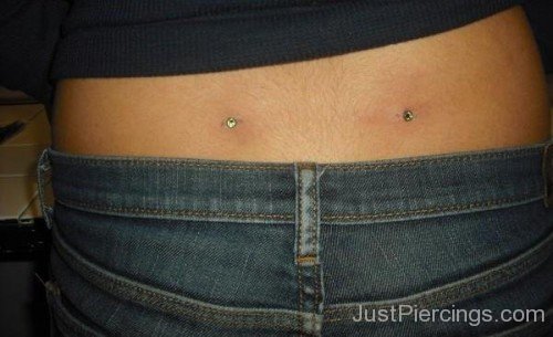 Back Dimple Piercing With Green Dermals