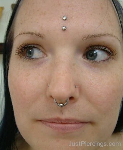 Septum And Vertical Third Eye Piercing