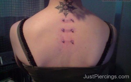 Arrows Tattoo And Surafce Piercings On Back-JP12004