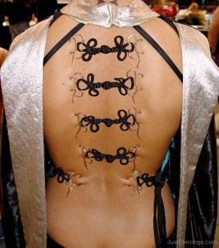 Back Piercing With Black Ribbons.
