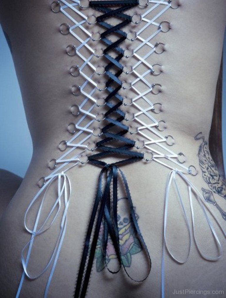 Corset Piercing On Back With Black And White Ribbons.