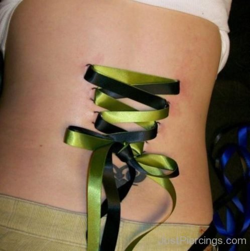 Corset Piercing With Black And Green Ribbon