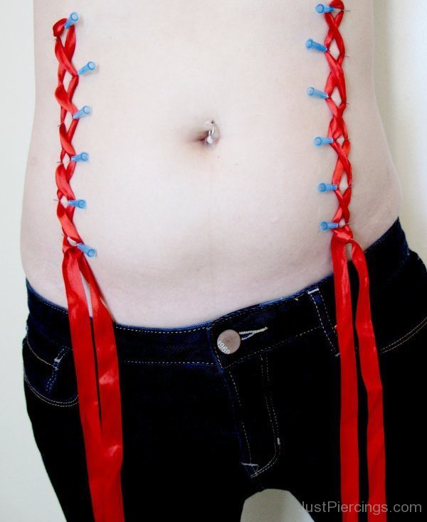 Corset Piercing With Red Ribbon.