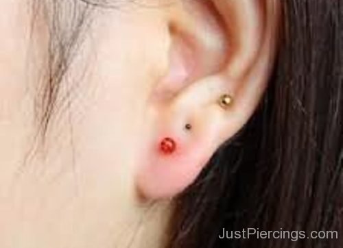 Ear Lobe Piercing With Red And Gold Stud-JP1178